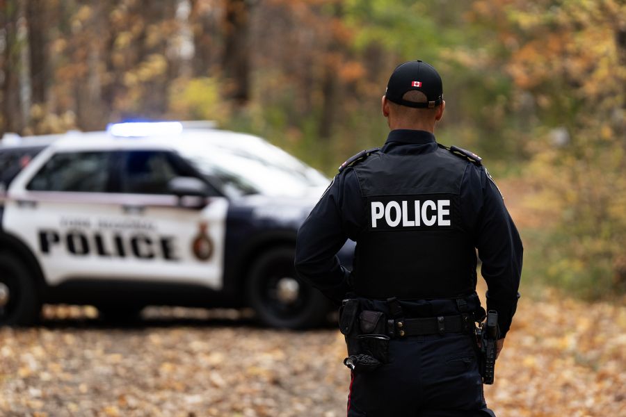 A man wears a uniform that reads POLICE
