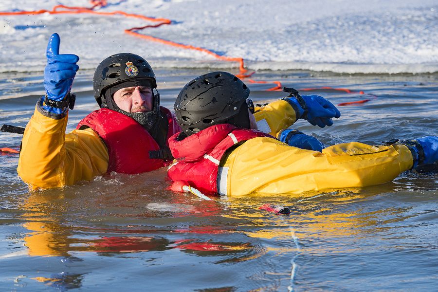An officer rescues a person who has fallen through ice in a training exercise