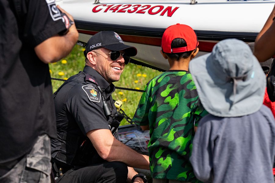 A marine officer speaks to children