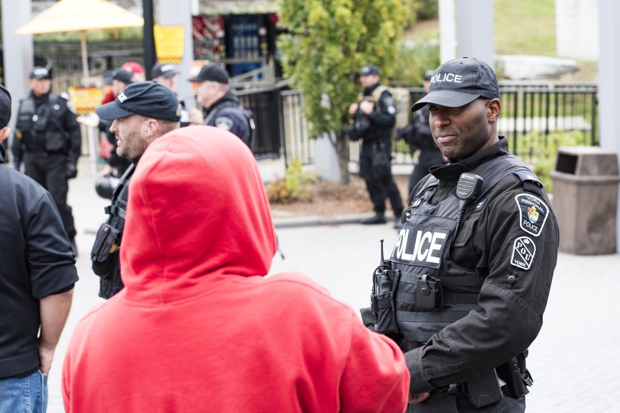 A police officer stands next to a crowd