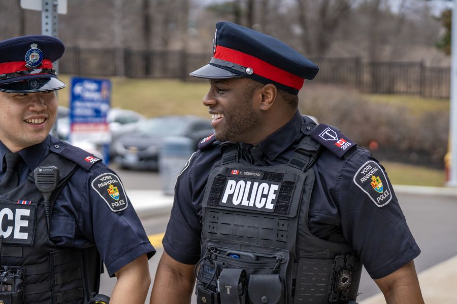 Two people in uniforms that read POLICE