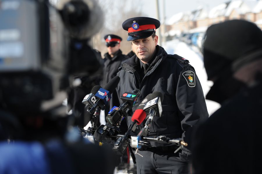 A media relations officer speaks to media