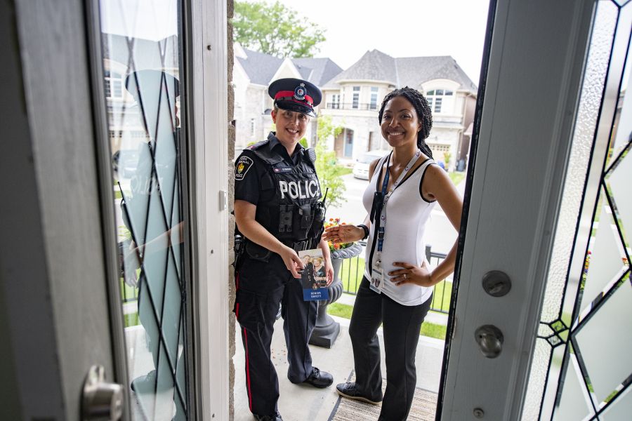 Two people, including one in uniform, at a door