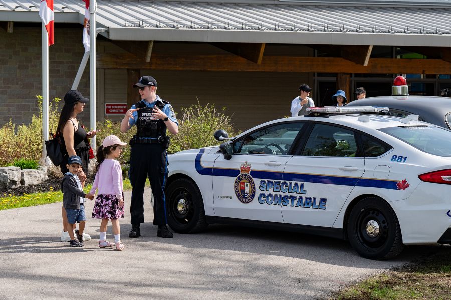 A Special Constable speaks to a woman and her children