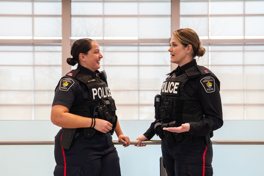 Two female officers speak to each other