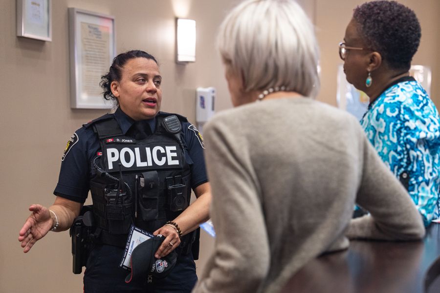 An officer speaks to a woman and an elderly woman