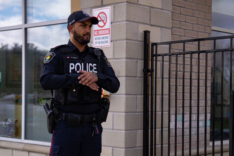 An officer stands outside a business
