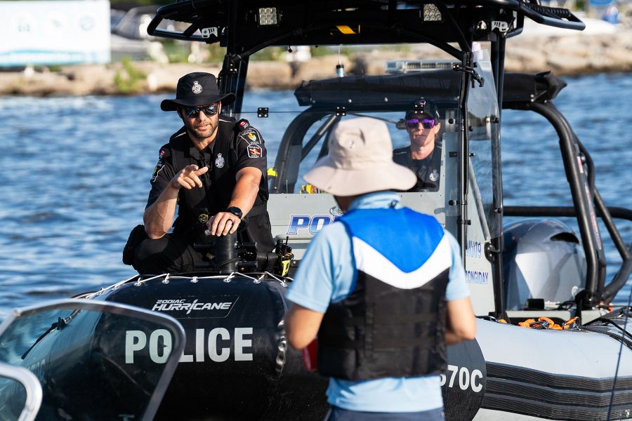 A police officer speaks to a man on a York Regional Police boat