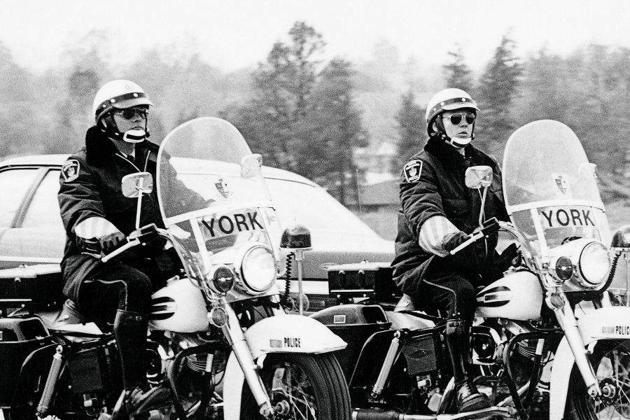 A black and white image of two police motorcycles