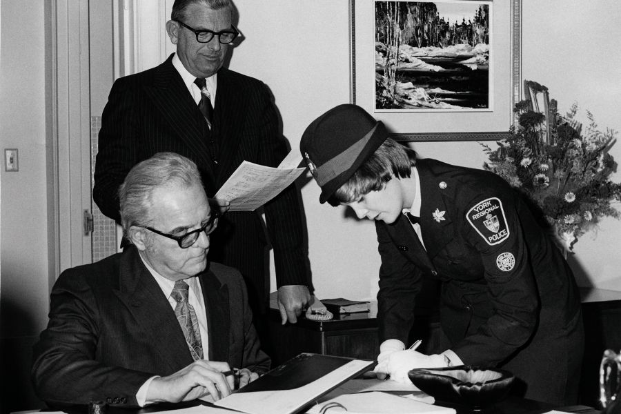 A woman signs a document