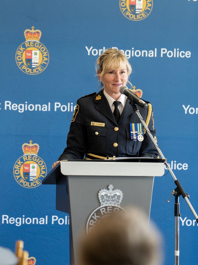 A woman in a police uniform at a podium