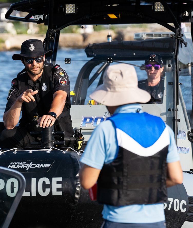 A police officer speaks to a man on a York Regional Police boat