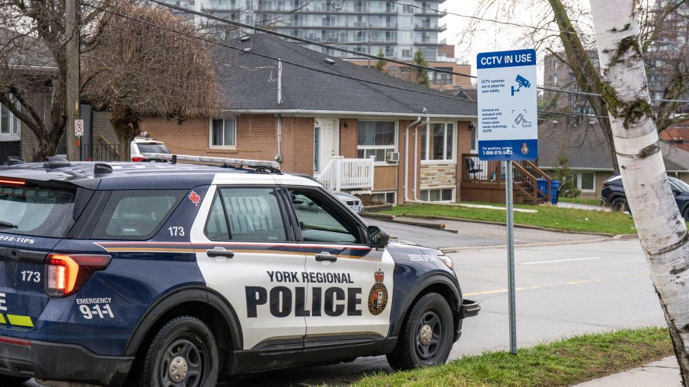 A police car next to a sign