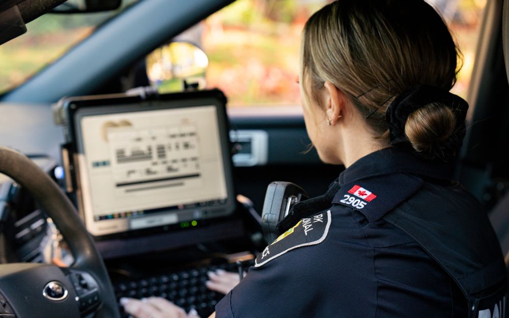 Police constable using an in car laptop