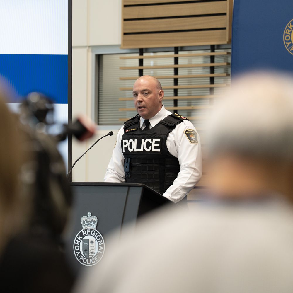 A man in a police uniform at a podium