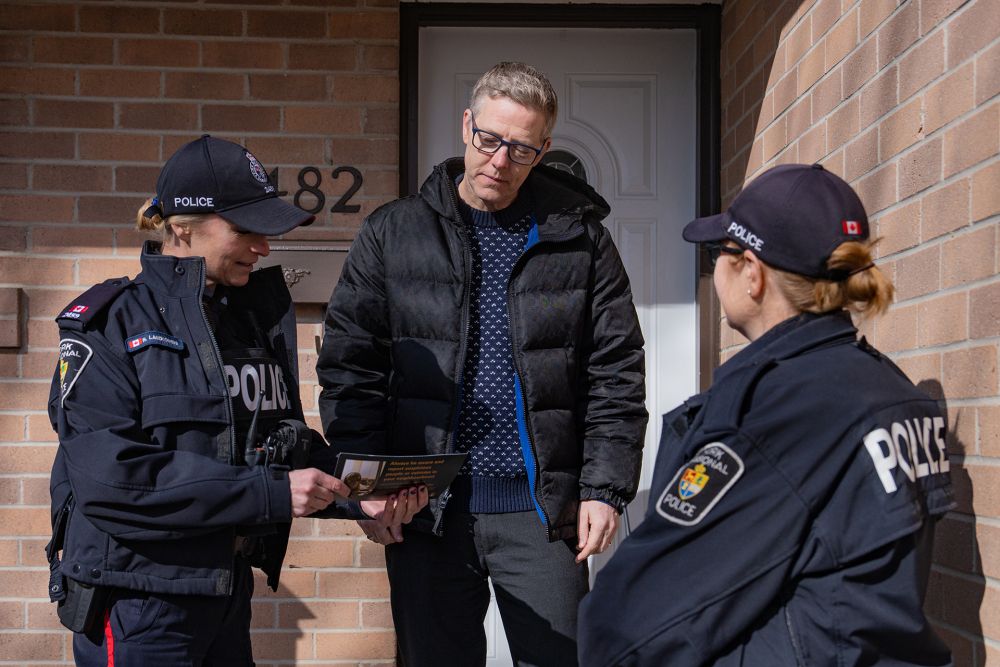 Two officers speak to a homeowner