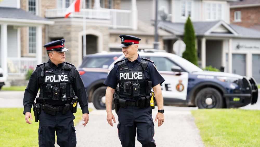 Two men in police uniforms walking