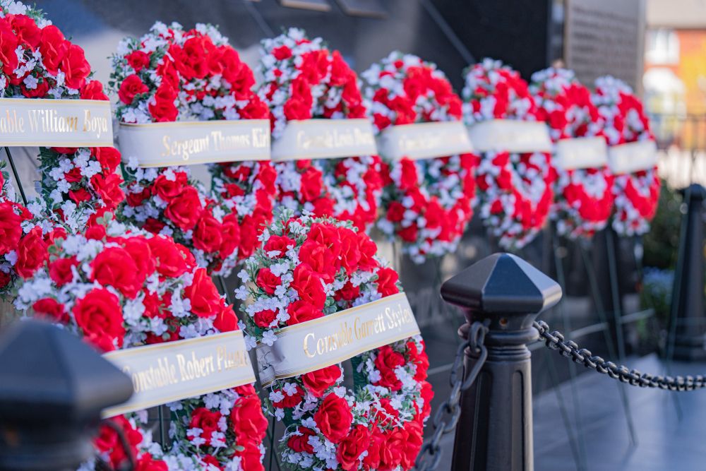 Wreaths with the names of fallen YRP officers are displayed at the #2 District memorial.