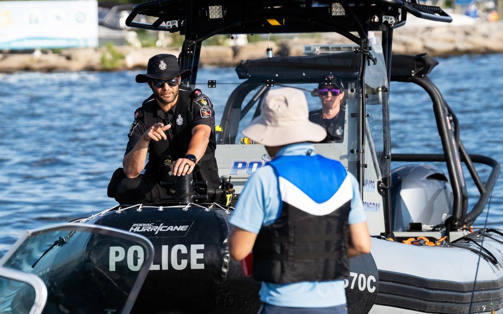 A police officer speaks to a man on a York Regional Police boat