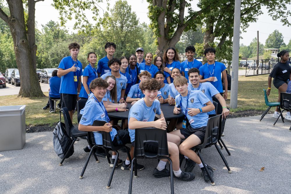 A group of teens in blue shirts